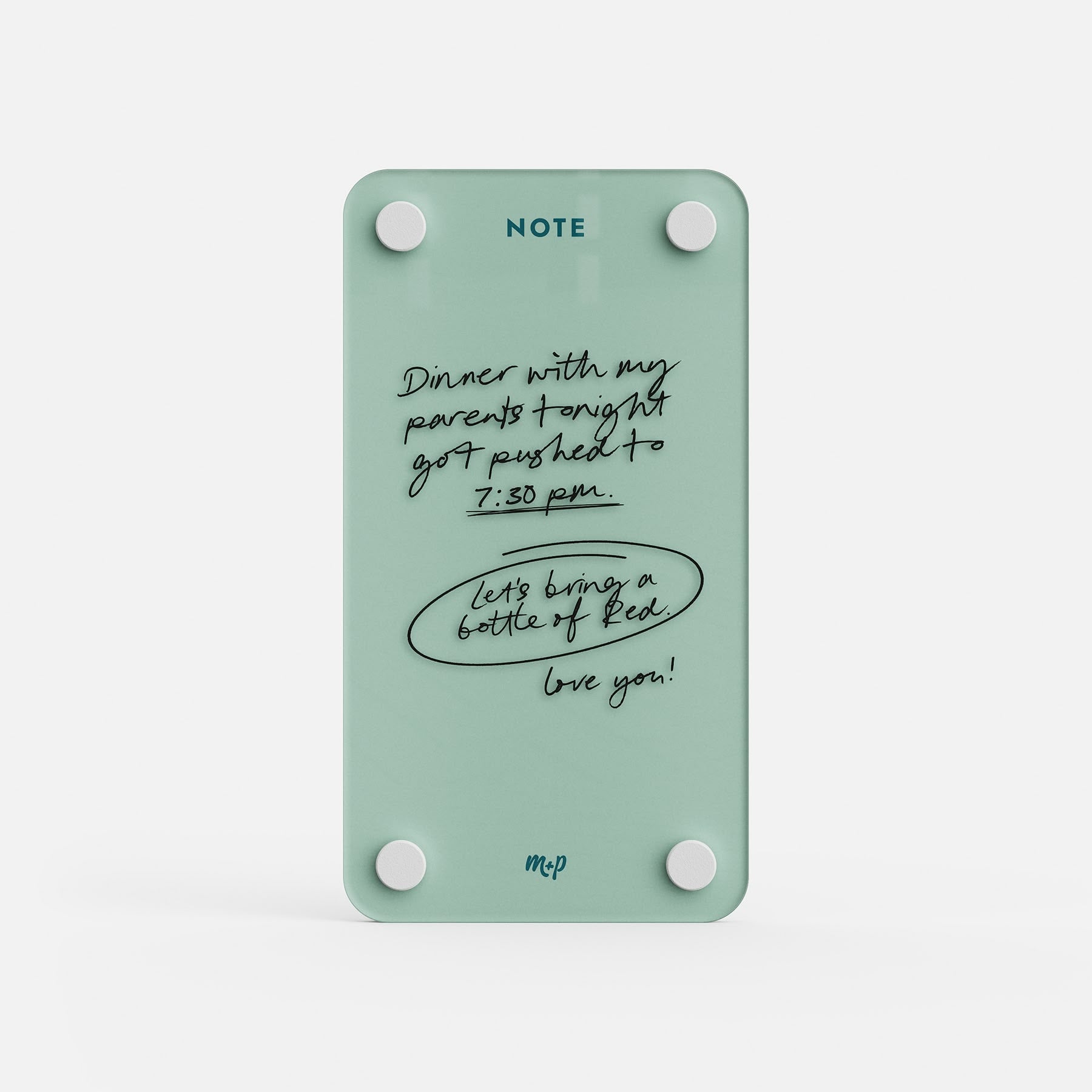 Seafoam green tall magnetic acrylic note board with a handwritten message about dinner moving to 7:30